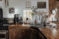 a kitchen with wooden counter tops and a sink