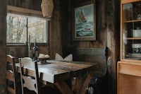 a wooden table and chairs in a cabin